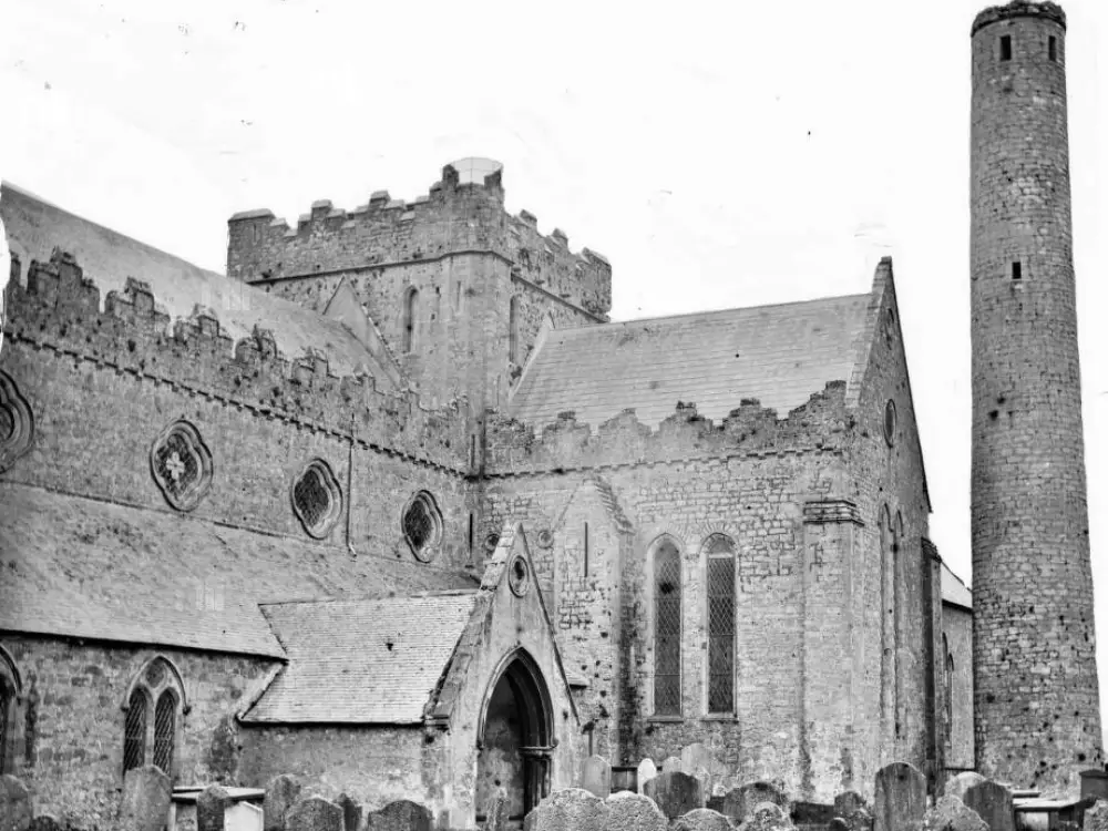 A historic image of St. Canice's Cathedral and Round Tower