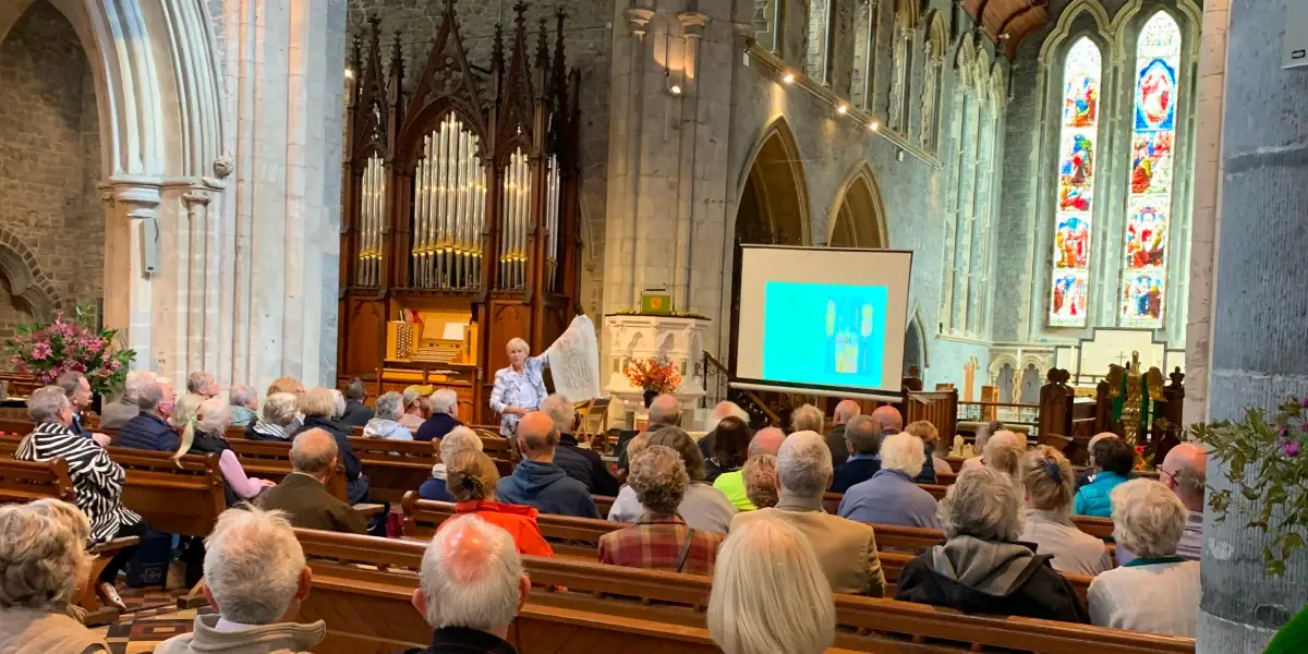 A large group of visitors at an event in St Canice's Cathedral.